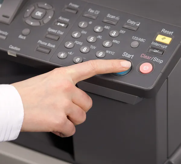 Hand pressing Start on copy machine — Stock Photo, Image