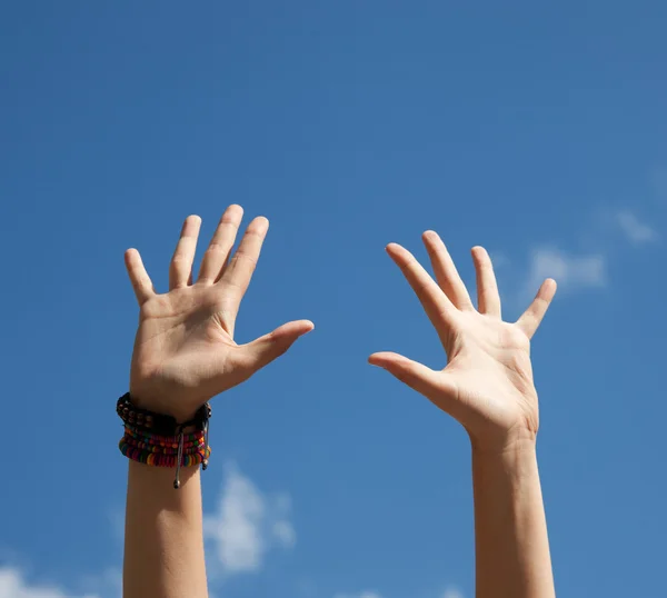 Handen tiseerde omhoog in de lucht langs hemel — Stockfoto