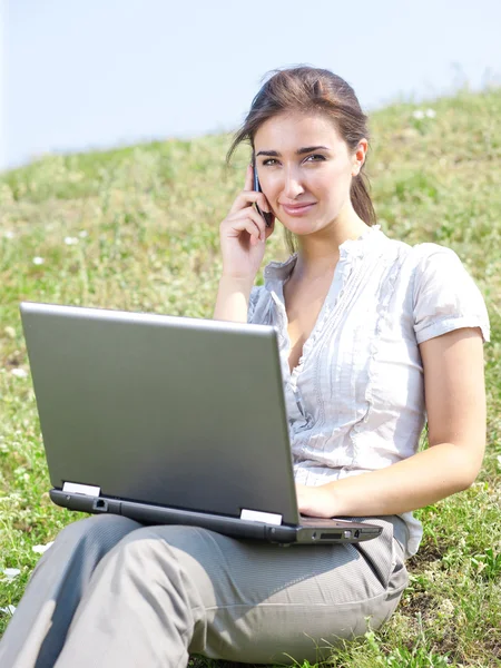 Woman with notebook sit on grass — Stock Photo, Image