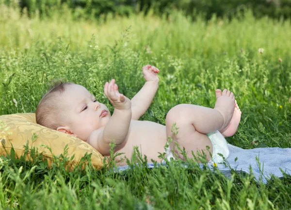 Baby lay on pillow in park — Stock Photo, Image