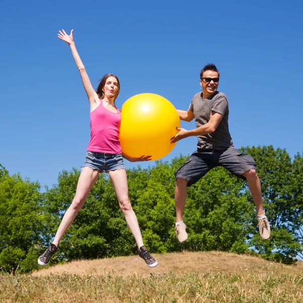 Young play with yellow ball — Stock Photo, Image