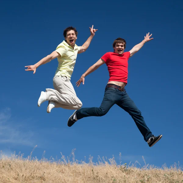 Young jump on hill in park — Stock Photo, Image