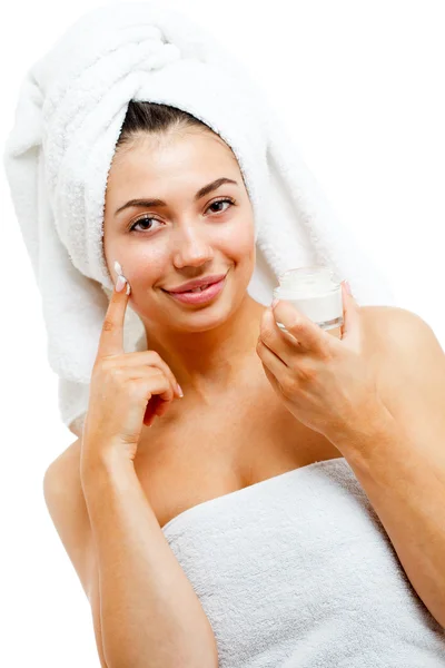 Beautiful women applying moisturizer cosmetic cream on face. — Stock Photo, Image