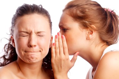 Young woman whispering something to her frind. clipart