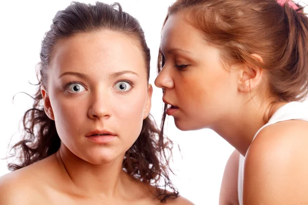 Young woman whispering something to her frind. — Stock Photo, Image