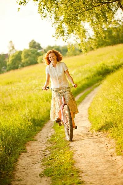 Young woman riding at bicycle — Stock Photo, Image