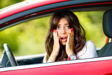 Young pretty woman in the red car clipart