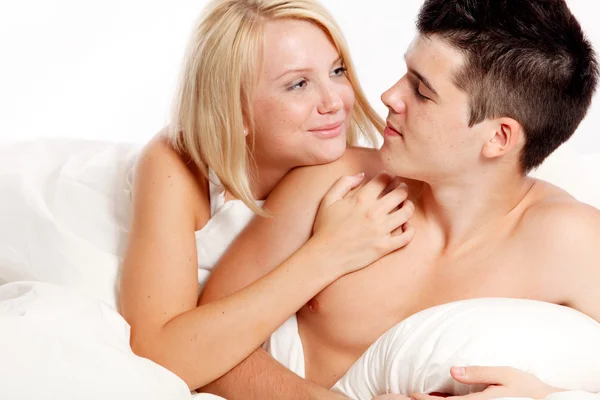 Loving affectionate heterosexual couple on bed. — Stock Photo, Image