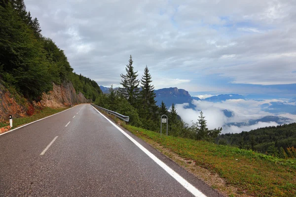 Route humide dans les nuages suisses à cumulus bas — Photo