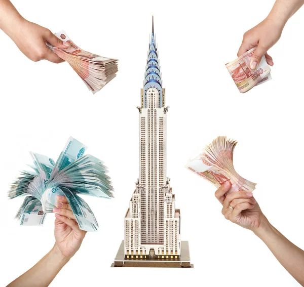 Model skyscraper "Chrysler Building" and the woman's hands — Stock Photo, Image