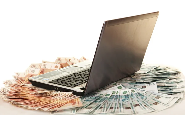Laptop on large pile of bills five thousandth — Stock Photo, Image