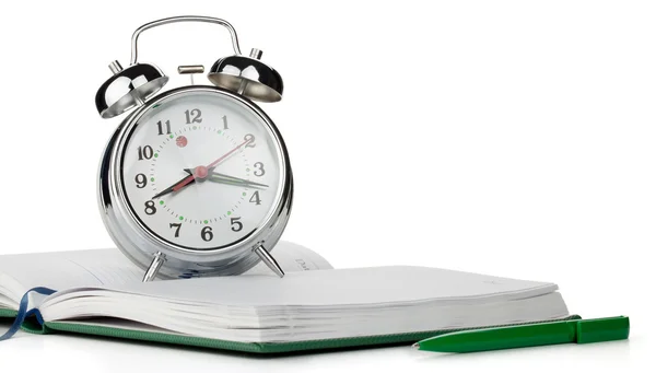Alarm clock on notepad — Stock Photo, Image