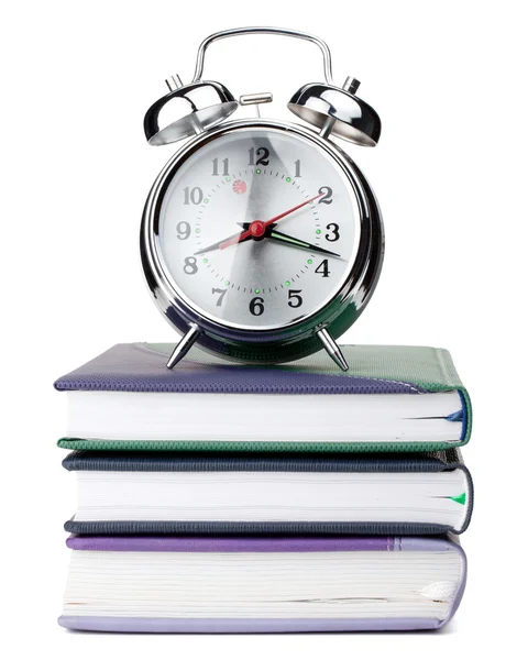 Alarm clock on notepads — Stock Photo, Image