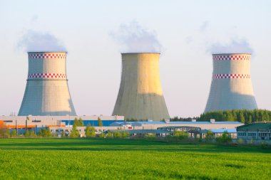 Power plant with huge cooling towers against blue sky clipart