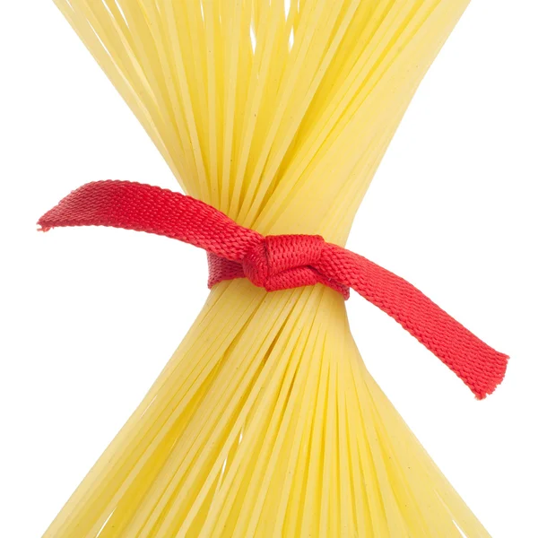 Bunch of spaghetti tied up with red ribbon isolated on white — Stock Photo, Image