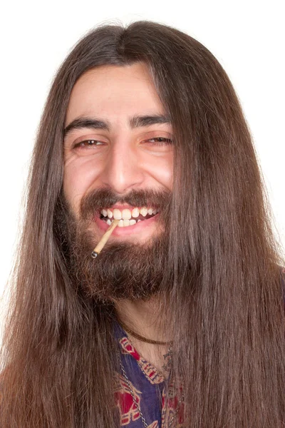Uomo hippie dai capelli lunghi che fuma sigarette o marijuana — Foto Stock