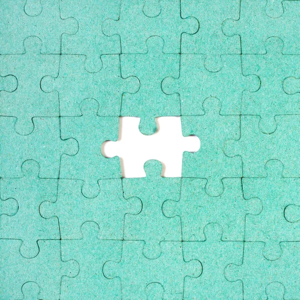 Green puzzle with missing piece — Stock Photo, Image