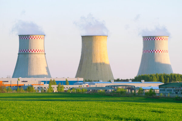 Power plant with huge cooling towers against blue sky