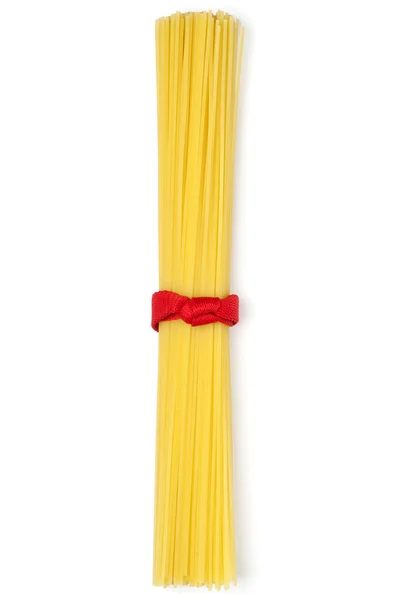 Bunch of spaghetti tied up with red ribbon isolated on white — Stock Photo, Image