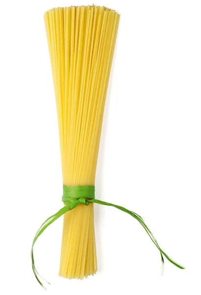 Bunch of spaghetti tied up with green ribbon isolated on white — Stock Photo, Image