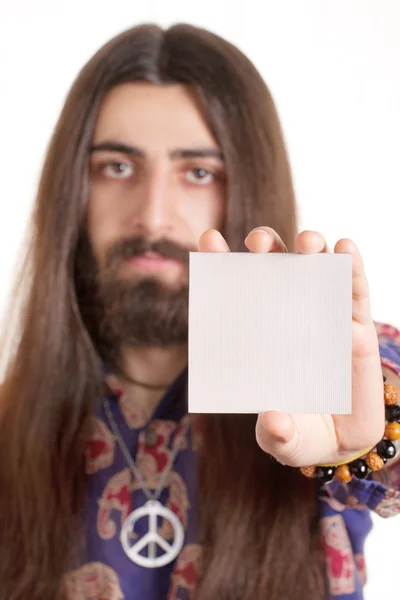 stock image Long-haired hippy man holding blank paper card