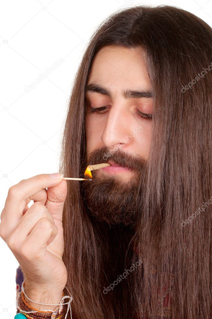 Long-haired hippie man smoking cigarette