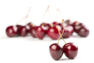 Red ripe cherries on white background clipart