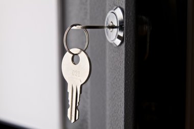 Key in the lock of the door clipart