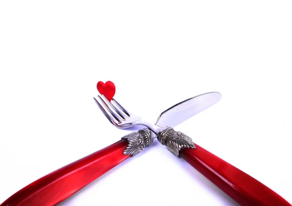 Red plug and knife near heart symbol — Stock Photo, Image