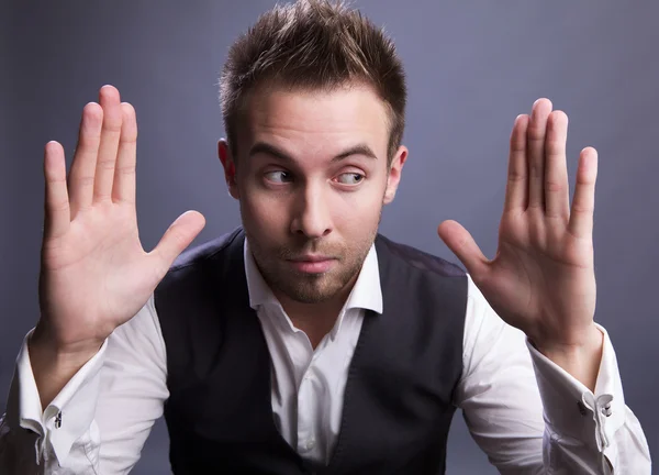 Young businessman holds on his hands empty space. — Stock Photo, Image
