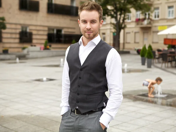 Young attractive man in urban background — Stock Photo, Image
