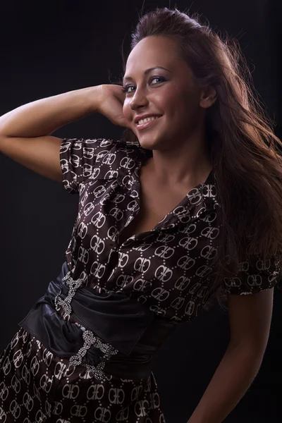 Beautiful brunette over dark background — Stock Photo, Image