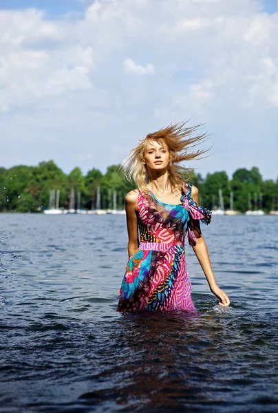 Beautiful blond model standing on water. Outdoor conceptual photo. — Stock Photo, Image