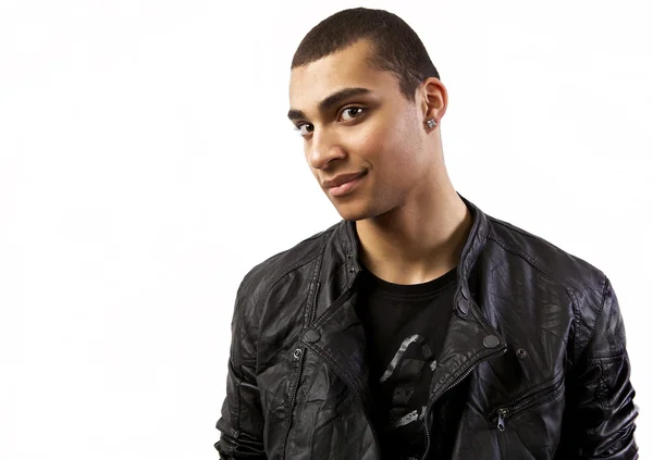 Attractive mulatto in a leather jacket on isolated studio background. — Stock Photo, Image