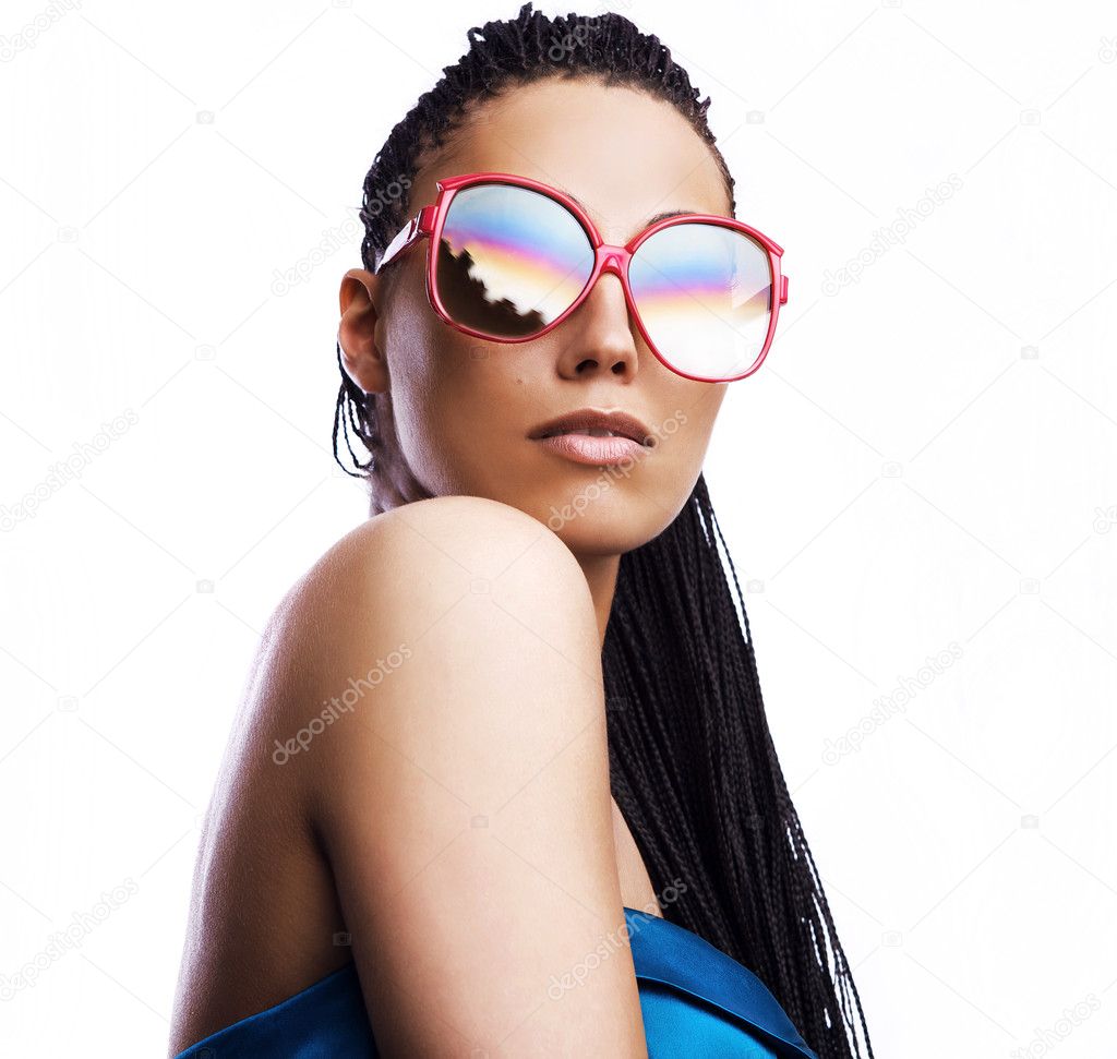 Beautiful fashion mulatto woman wearing sunglasses over a white background.