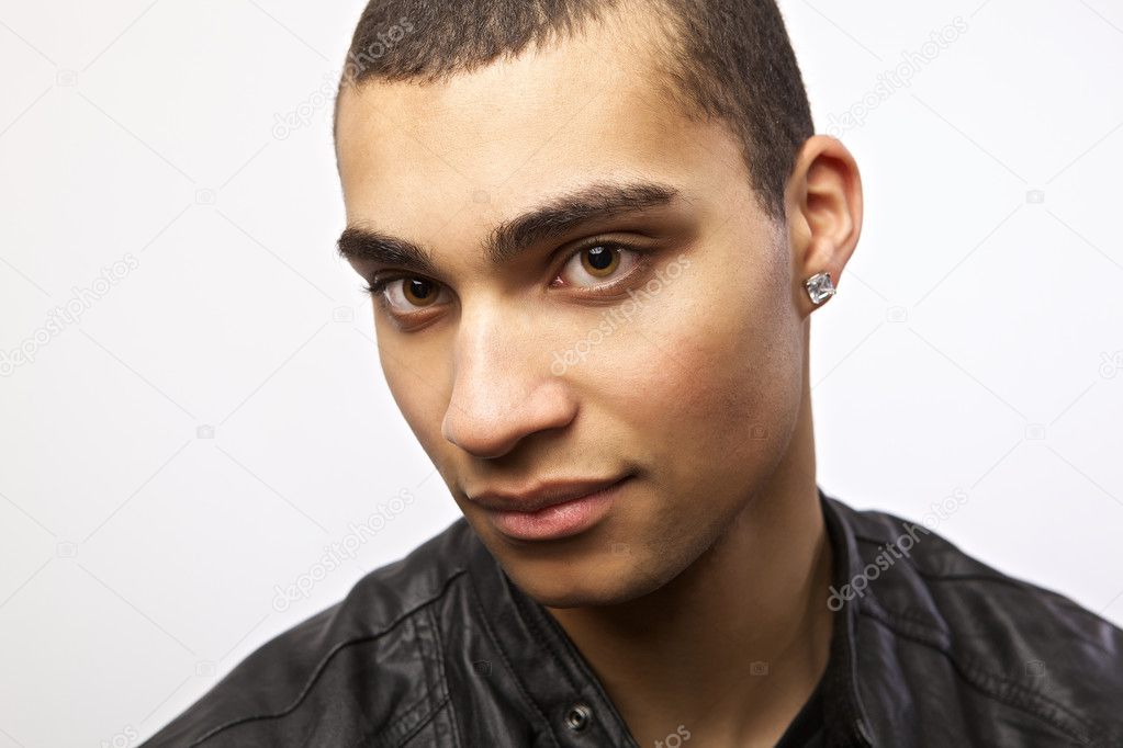 Attractive mulatto in a leather jacket on isolated studio background ...