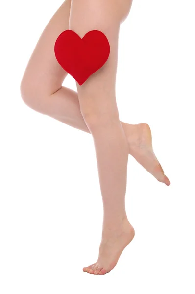 Female legs with red heart — Stock Photo, Image