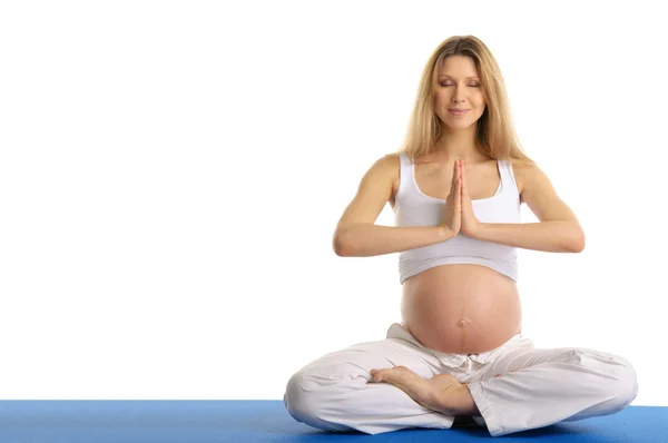 Pregnant woman with ??eyes closed practicing yoga — Stock Photo, Image
