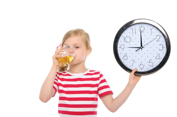 Girl with clock drinking juice from glass — Stock Photo, Image