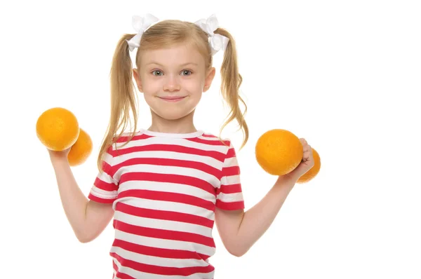 Girl trains fitness dumbbells of oranges — Stock Photo, Image