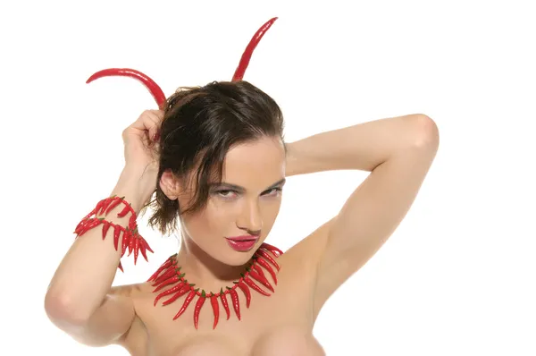 Woman with jewelry and horns of red hot pepper — Stock Photo, Image