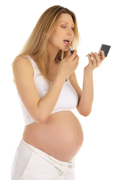 Gravid kvinna och spegel med läppstift — Stockfoto
