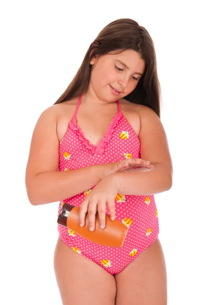 Chica en traje de baño aplicando loción solar —  Fotos de Stock