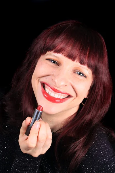 Redhead holding lipstick tube — Stock Photo, Image