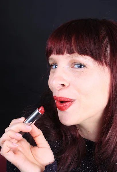 Rotschopf hält Lippenstift-Tube — Stockfoto