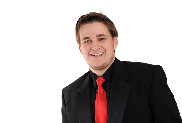 Jovem empresário em terno formal preto sorrindo — Fotografia de Stock