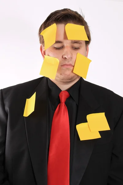 Aburrido hombre de negocios con papel de nota adhesiva —  Fotos de Stock