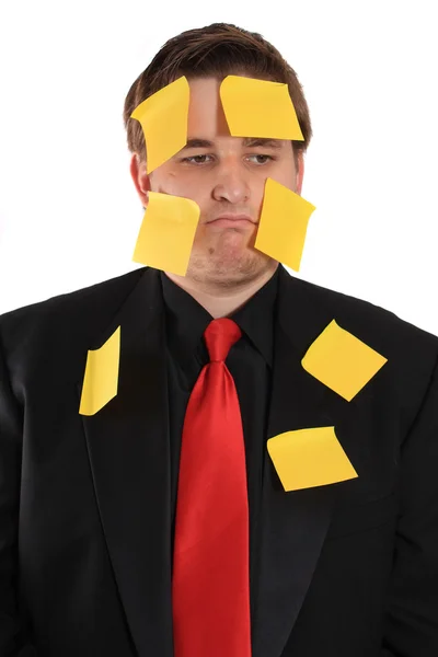 Geschäftsmann mit klebrigem Zettelpapier im Gesicht — Stockfoto