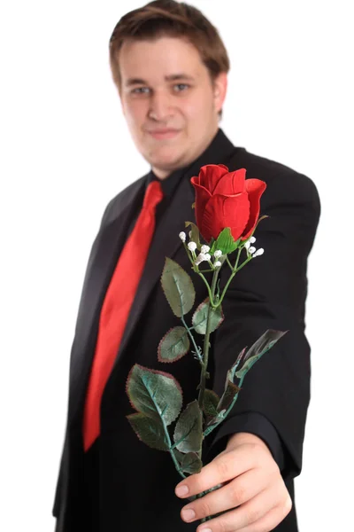 Young man offering you a rose — Stock Photo, Image