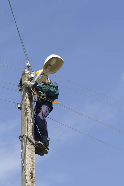Elektrikçi işçi onarım lambalar — Stok fotoğraf